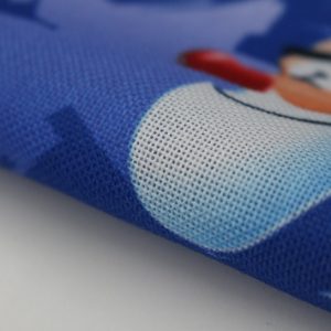 close up view a blue spun polyester fabric banner with a clown